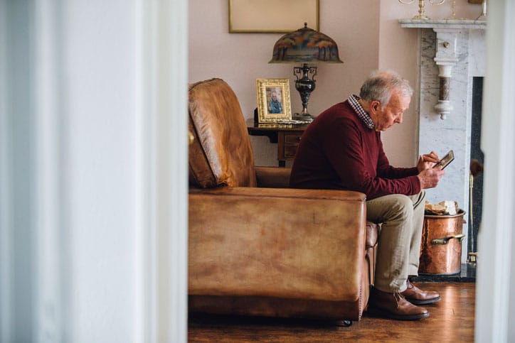 Senior Grieving in Chair