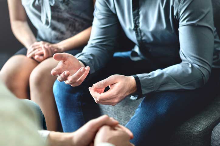 Close up of hands at counseling session.