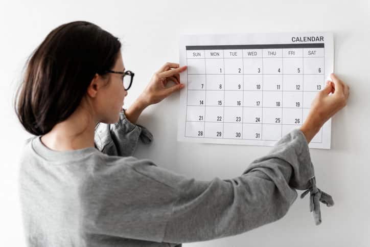 Woman checking the mental health awareness calendar