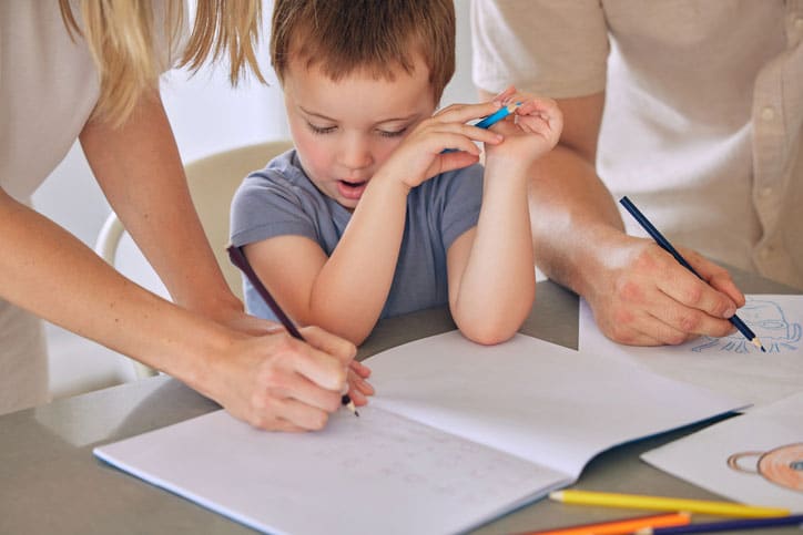 Parents Hovering Over Child With Autism