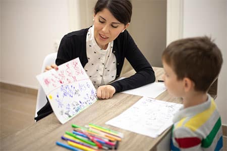 Woman with Boy Performing Autism Testing in Ann Arbor MI