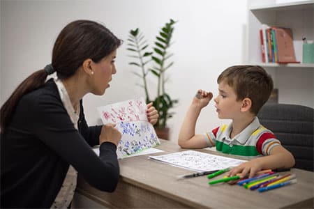 Woman with Boy Performing Autism Testing in Michigan