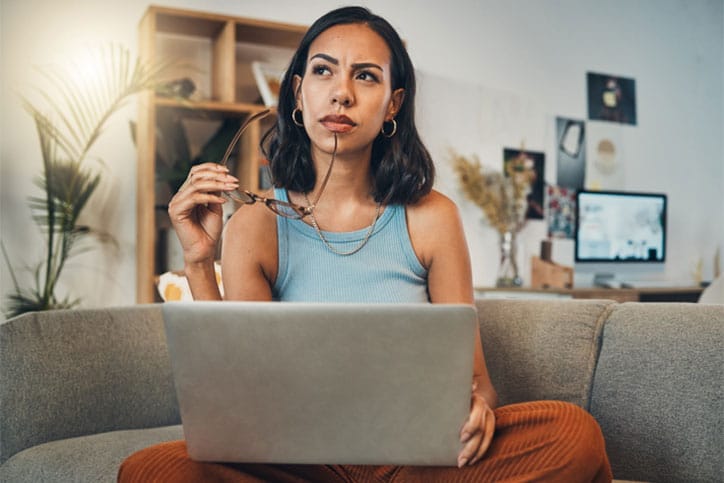 Woman Thinking with Laptop and Brain Fog