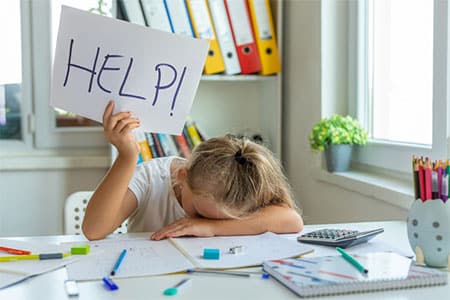 Child Holding Help Sign in Need of Dyslexia Testing in Metro Detroit