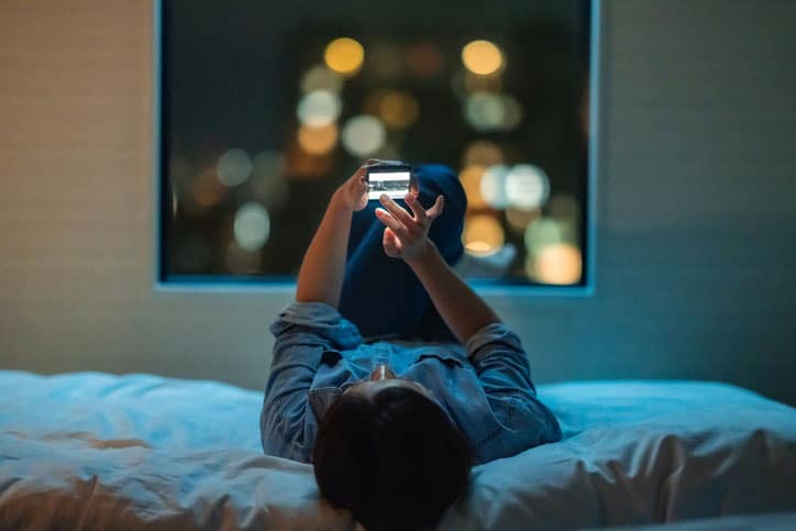 Woman Sleeping on Back with Phone