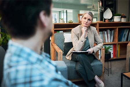 Woman with Young Man Performing Learning Disability Testing near Ypsilanti MI