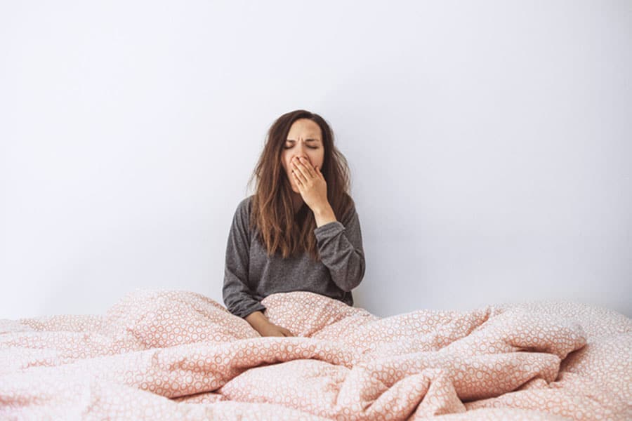 Tired Woman in Bed